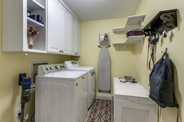 laundry room with washer and dryer, cabinet space, baseboards, and light tile patterned floors