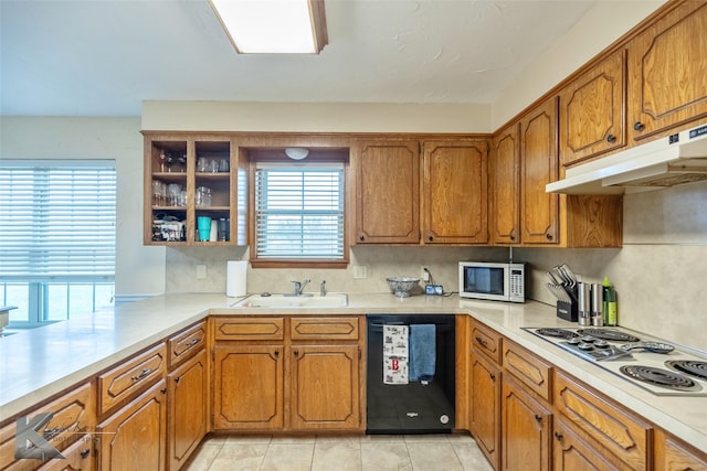 kitchen with stainless steel gas cooktop, kitchen peninsula, black dishwasher, sink, and light tile patterned flooring