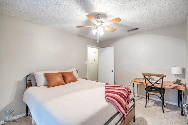 carpeted bedroom with a textured ceiling and ceiling fan