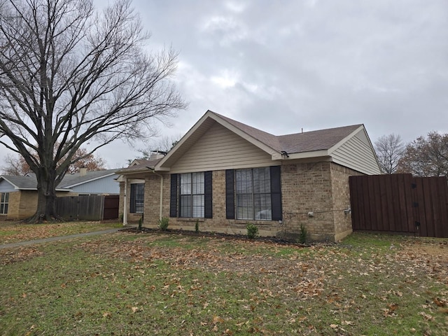 ranch-style house with a front lawn