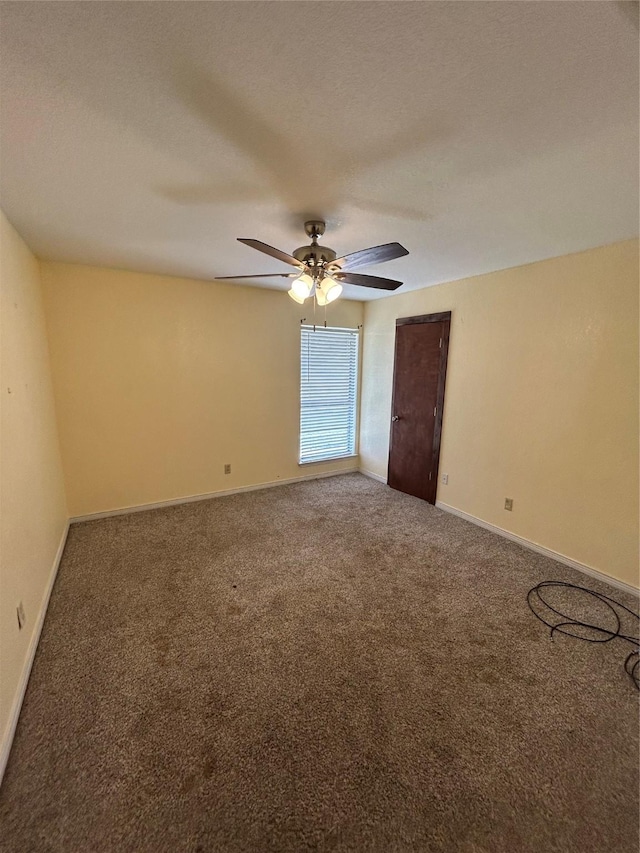 carpeted empty room featuring a textured ceiling and ceiling fan