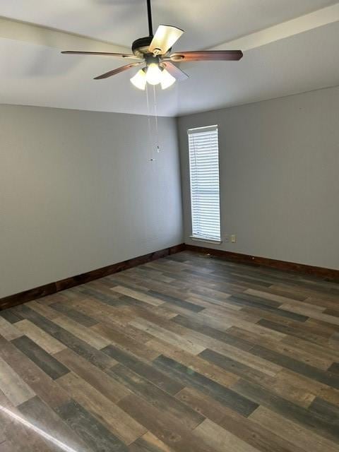 empty room featuring ceiling fan and dark hardwood / wood-style floors