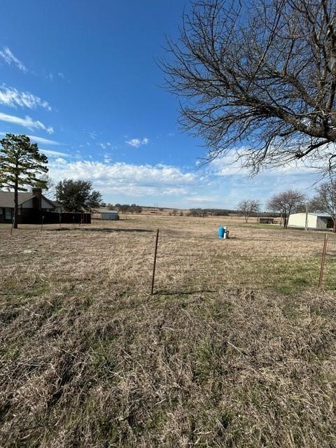 view of yard with a rural view