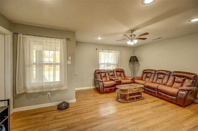 living room with light hardwood / wood-style flooring and ceiling fan