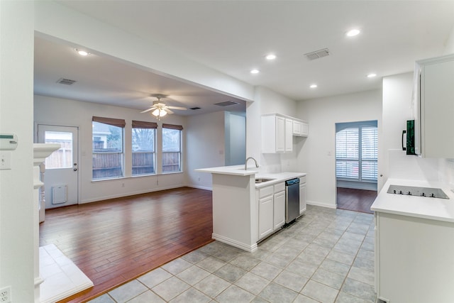 kitchen featuring white cabinetry, kitchen peninsula, sink, stainless steel dishwasher, and ceiling fan