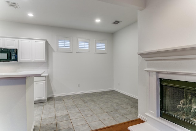 kitchen with white cabinets and light tile patterned flooring