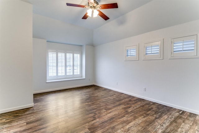 empty room featuring ceiling fan, vaulted ceiling, and dark hardwood / wood-style floors