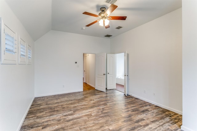 unfurnished room with ceiling fan, vaulted ceiling, and dark hardwood / wood-style floors