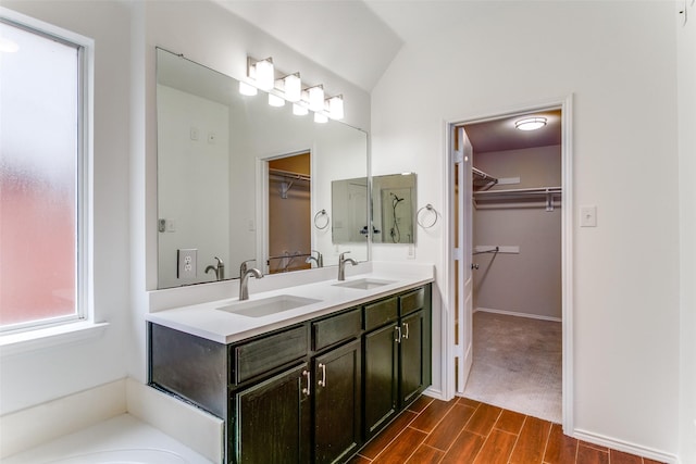 bathroom with vanity and vaulted ceiling