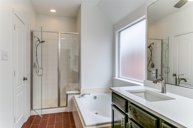 bathroom featuring separate shower and tub and vanity