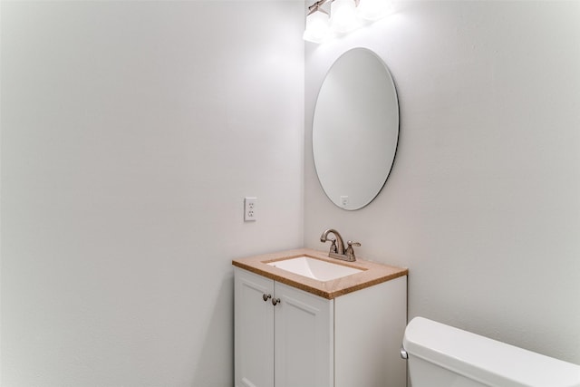 bathroom featuring toilet and vanity