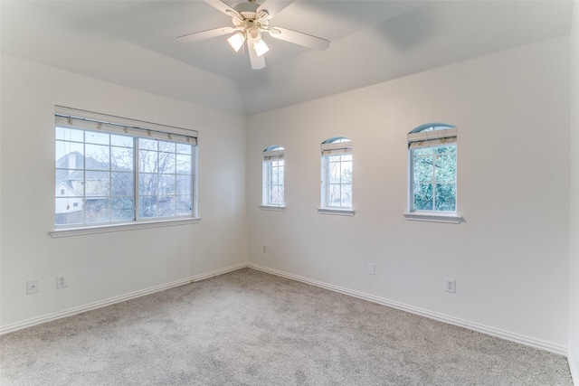 empty room featuring light carpet, lofted ceiling, and ceiling fan