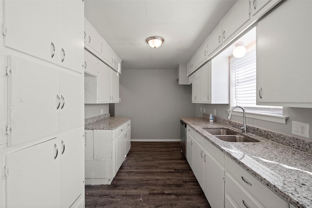 kitchen with white cabinetry, sink, light stone counters, dishwasher, and dark hardwood / wood-style floors