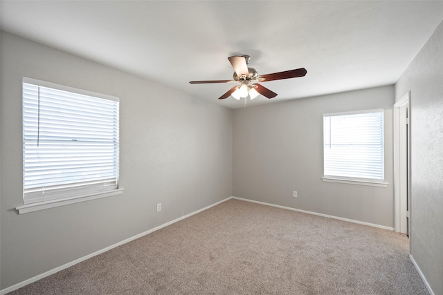 unfurnished room with light carpet and ceiling fan