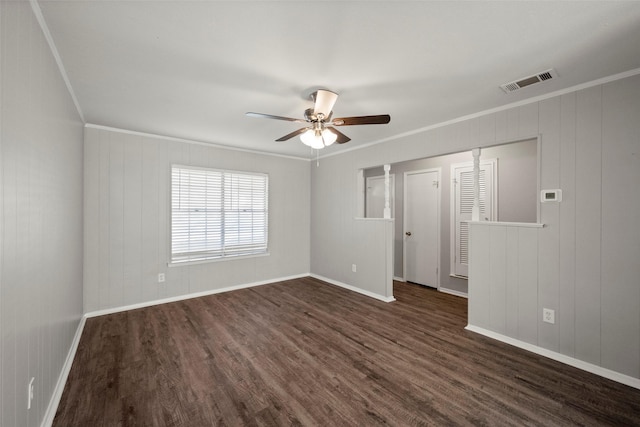 empty room featuring ceiling fan, ornamental molding, and dark hardwood / wood-style flooring