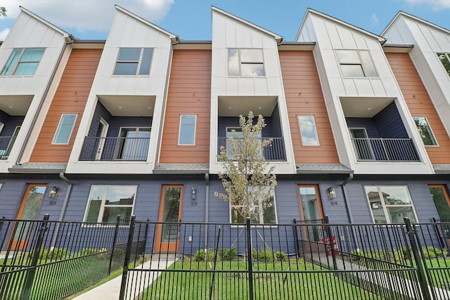 view of building exterior with a fenced front yard