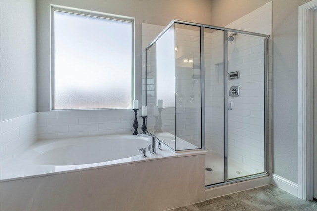 bathroom with a stall shower and a bath