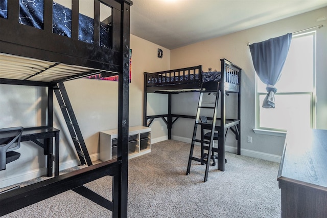 bedroom with carpet flooring and baseboards