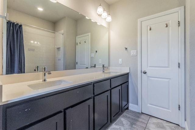 full bath featuring double vanity, curtained shower, and a sink