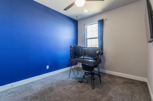 carpeted home office featuring a ceiling fan and baseboards