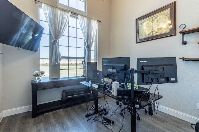 office space featuring baseboards and wood finished floors