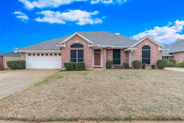 view of front of home with a front lawn and a garage