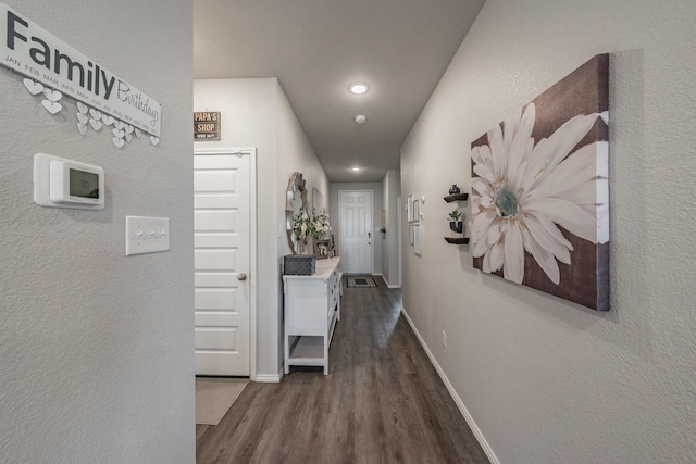 hall with dark hardwood / wood-style flooring