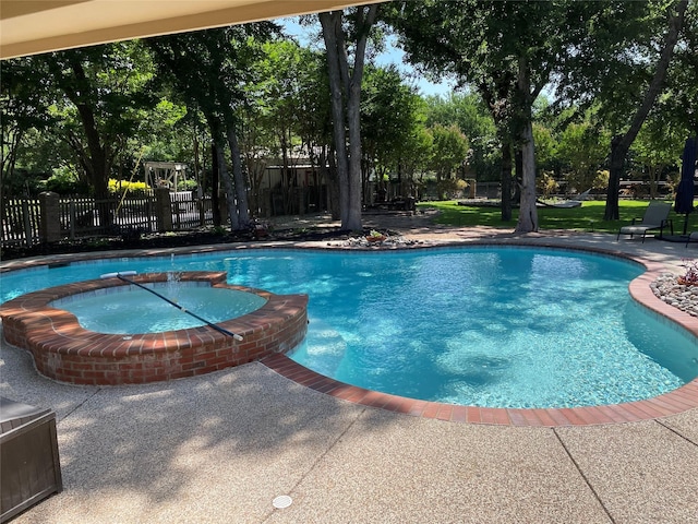 view of pool featuring a patio and an in ground hot tub