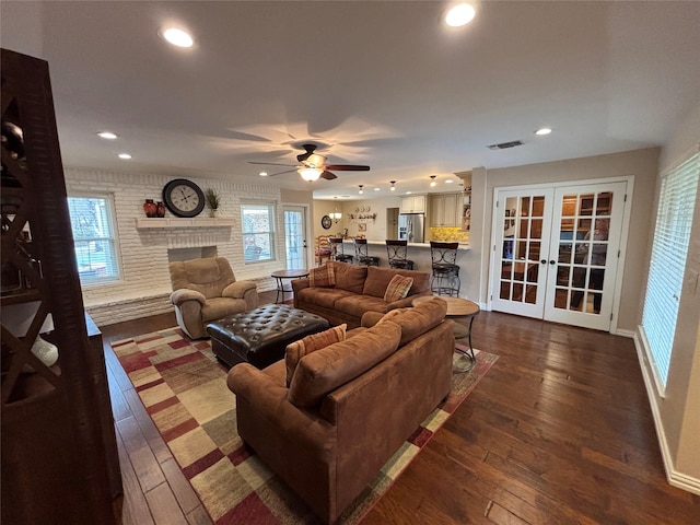 living room featuring a fireplace, french doors, ceiling fan, and dark hardwood / wood-style flooring