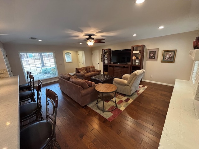 living room featuring dark hardwood / wood-style floors and ceiling fan