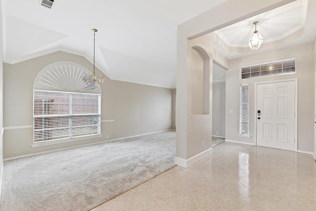 foyer entrance with vaulted ceiling, a chandelier, crown molding, and light colored carpet