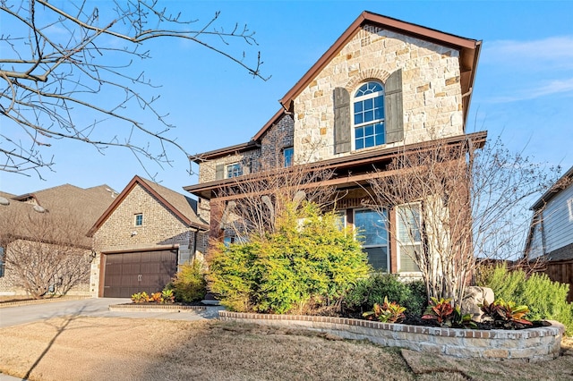 view of front facade with stone siding, concrete driveway, and a garage