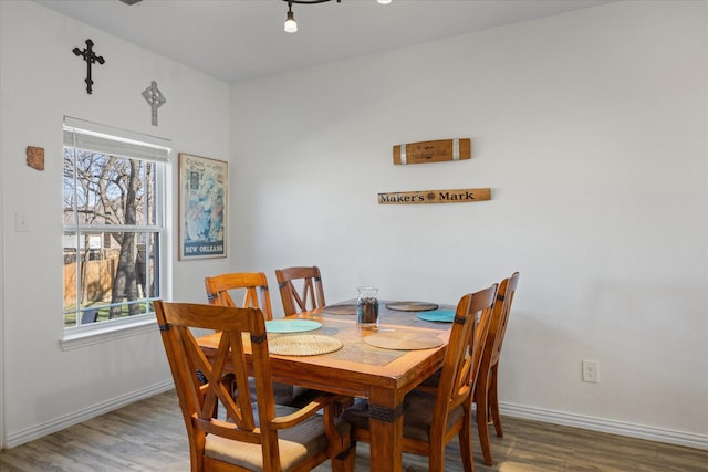 dining area featuring wood finished floors, a wealth of natural light, and baseboards