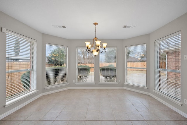 unfurnished dining area featuring light tile patterned flooring and a chandelier