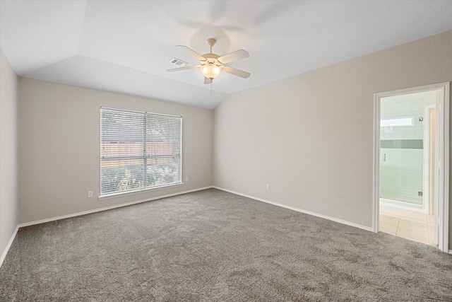 empty room with lofted ceiling, ceiling fan, and carpet flooring