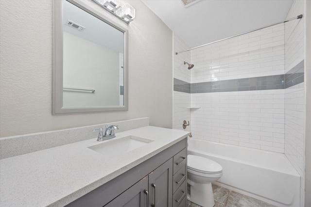 full bathroom featuring vanity, toilet, and tiled shower / bath