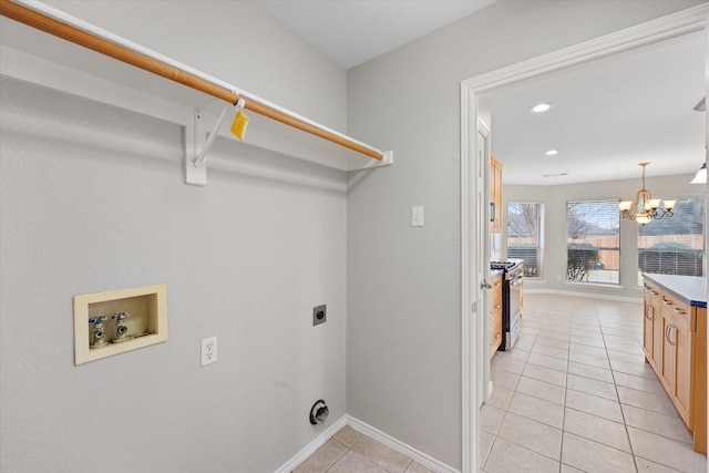 washroom with washer hookup, light tile patterned floors, a notable chandelier, and electric dryer hookup