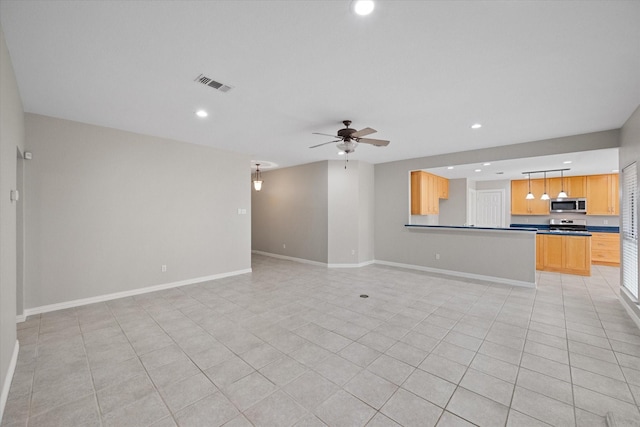 unfurnished living room featuring ceiling fan and light tile patterned floors