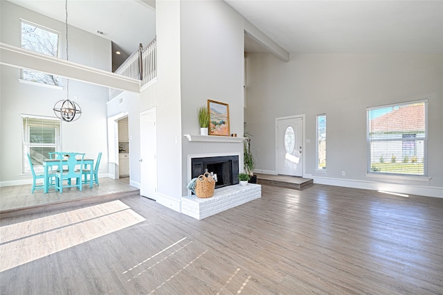 2529 Guerrero Dr, Carrollton, TX 75006 - unfurnished living room with a wealth of natural light, high vaulted ceiling, and an inviting chandelier