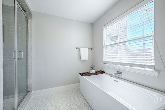 2529 Guerrero Dr, Carrollton, TX 75006 - bathroom with a shower stall, a soaking tub, and baseboards