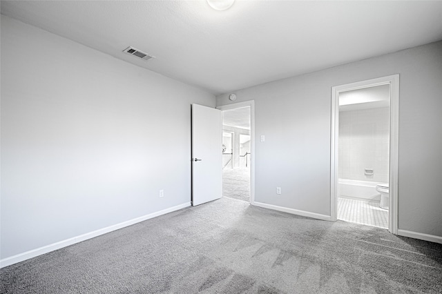 2529 Guerrero Dr, Carrollton, TX 75006 - unfurnished bedroom featuring visible vents, baseboards, carpet floors, and connected bathroom