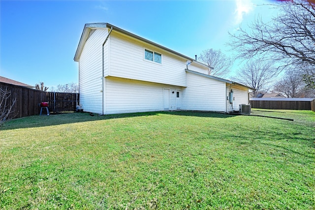 2529 Guerrero Dr, Carrollton, TX 75006 - back of house featuring a fenced backyard, a yard, and central AC
