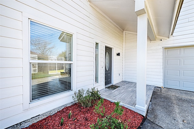 doorway to property with a garage