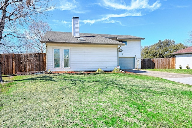 2529 Guerrero Dr, Carrollton, TX 75006 - rear view of property with a lawn, a chimney, driveway, an attached garage, and fence