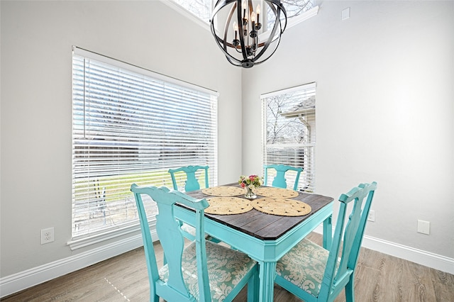 2529 Guerrero Dr, Carrollton, TX 75006 - dining room with wood finished floors, baseboards, and a notable chandelier