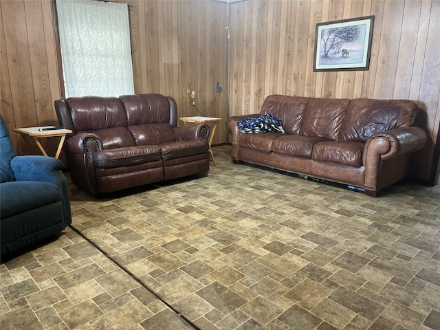 living area with stone finish floor and wooden walls