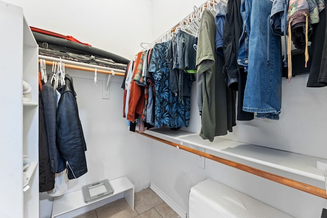 walk in closet with light tile patterned floors