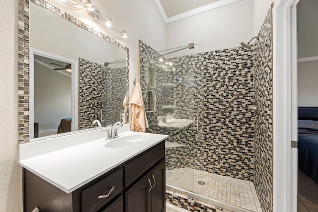 bathroom with vanity, crown molding, and a shower with shower door