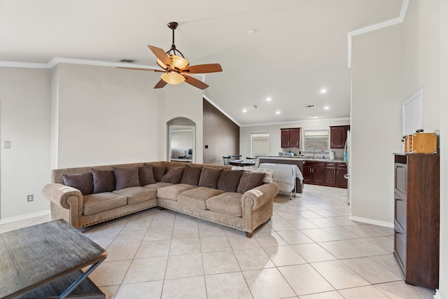 living room with sink, light tile patterned flooring, ceiling fan, high vaulted ceiling, and ornamental molding