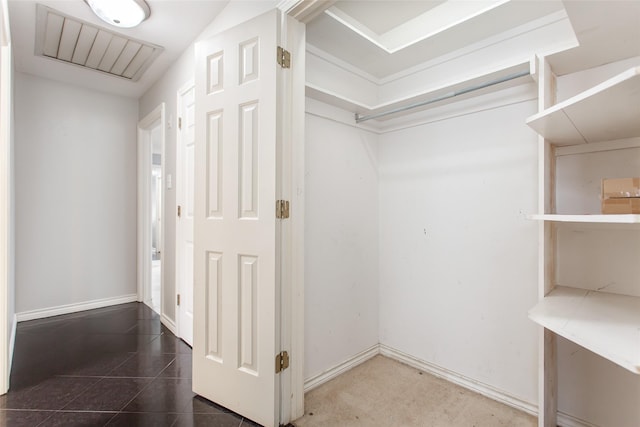 walk in closet with tile patterned flooring